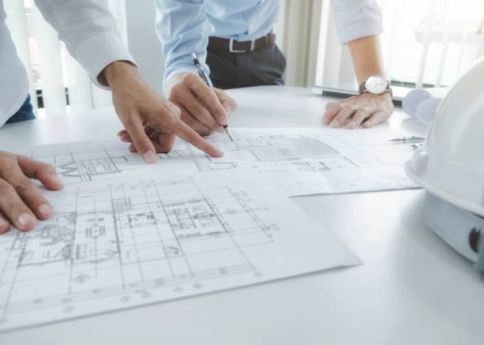 Image of engineer meeting for architectural project. working with partner and engineering tools on workplace vintage tone.