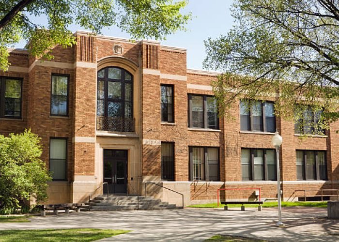 A building exterior on a school campus that may be a university lecture hall, college dorm, schoolhouse, or other higher education architecture.